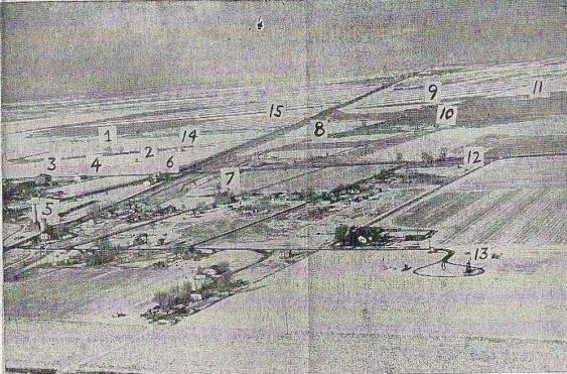 An aerial photograph of the town and surrounding fields, with well sites marked.